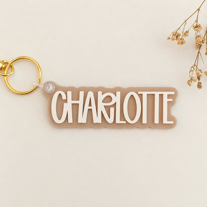 Solid color acrylic name keychain spelling Charlotte with gold keyring.