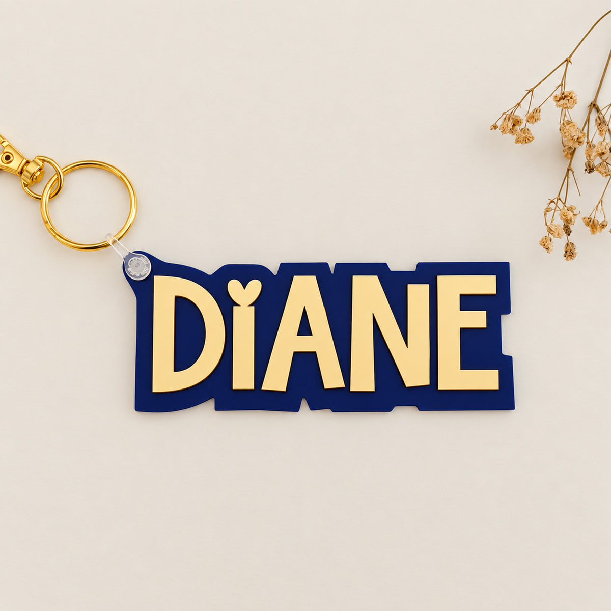 Solid color acrylic name keychain spelling Diane with gold keyring.
