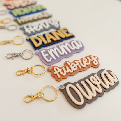 Group of personalized solid color acrylic name keychains in assorted colors.