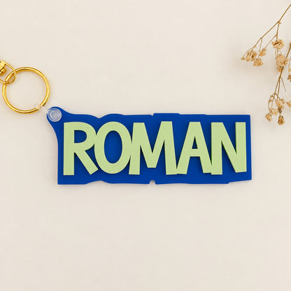 Solid color acrylic name keychain spelling Roman with gold keyring.